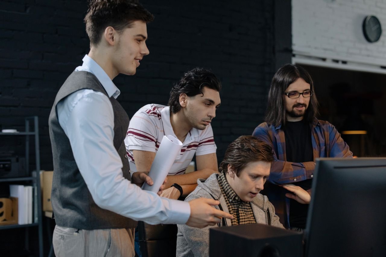 Group of young professionals collaborating on a project in a modern office environment.